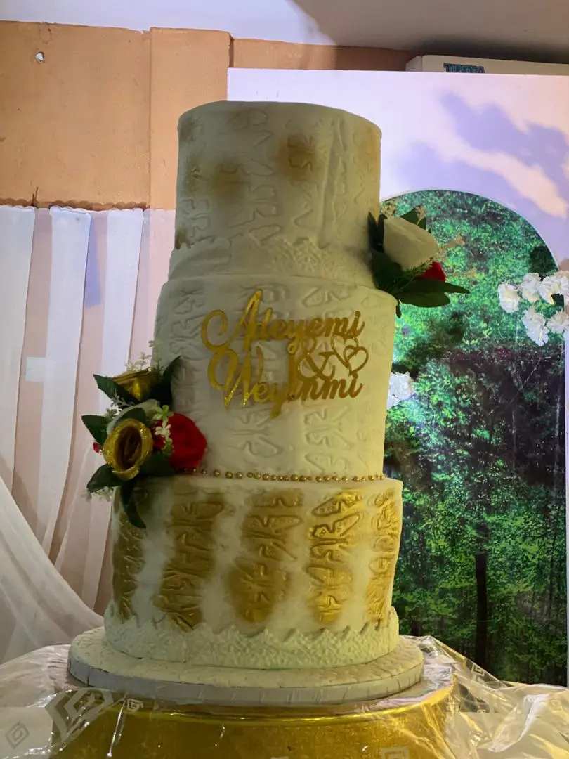 A beautifully decorated custom wedding cake with elegant detailing